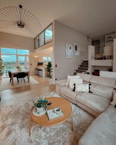 a living room filled with furniture and lots of windows