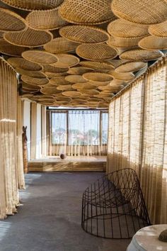 an empty room with lots of wicker covering the ceiling