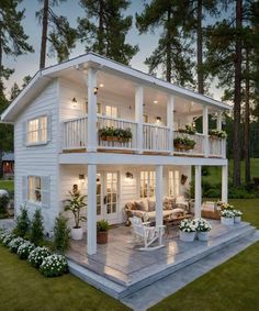 a large white house sitting on top of a lush green field