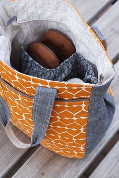 an orange and white bag sitting on top of a wooden table