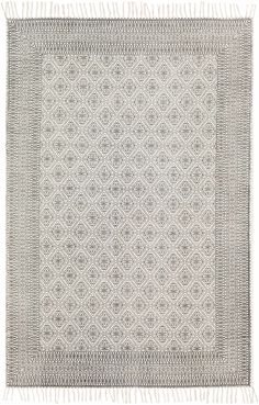 a gray and white rug with fringes on the bottom, in front of a white background