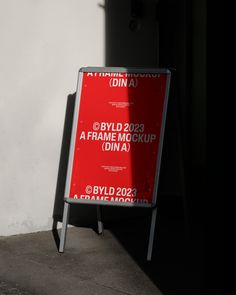 a red sign sitting on the side of a building