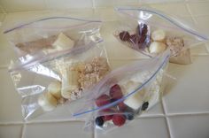 two bags filled with food sitting on top of a tiled floor