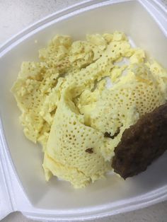 a plastic container filled with food on top of a table