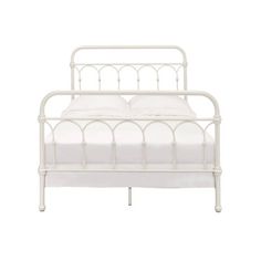 a white metal bed frame with two pillows