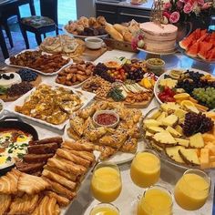 a table filled with lots of different types of food and drinks next to each other