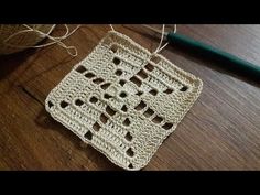 a crocheted square is sitting on a table