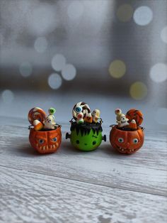 three small pumpkins with animals in them