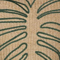 a close up view of the back side of a piece of woven material with green lines on it