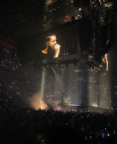 the stage is lit up with bright lights and people in the audience are looking on