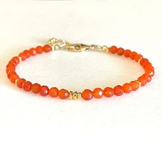 Dainty dainty carnelian gemstone bracelet with 24k gold vermeil and gold fill accents.  Natural translucent orange faceted 4mm carnelian rounds are accented with 24k gold vermeil. Bracelet closes with 14k gold fill lobster claw clasp and 1 inch extension.  Made to order. When selecting size please add 1/2 to 3/4 inch to actual wrist measurement for a comfortable fit. Also available in .925 sterling silver. Adjustable Gold Carnelian Beaded Bracelets, Gold Carnelian Beaded Bracelets For Spiritual Wear, Handmade Gold Carnelian Bracelets, Autumn Bracelet, Malachite Earrings, Armband Gold, Orange Carnelian, Carnelian Bracelet, Carnelian Jewelry