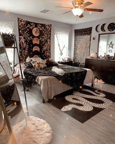 a bedroom decorated in black and white with lots of decorations on the walls, flooring and rugs