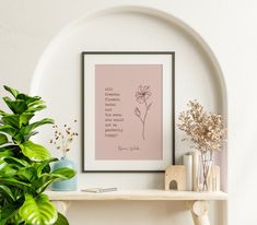 a shelf with some plants and vases on it next to a framed quote that reads, one orchid is the only flower