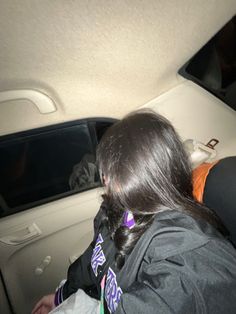 a woman sitting in the back seat of a car