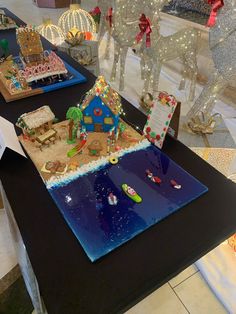 gingerbread houses are on display in a store with christmas lights and decorations around them