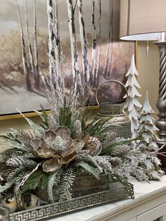 a white fireplace mantel topped with a potted plant next to a christmas tree