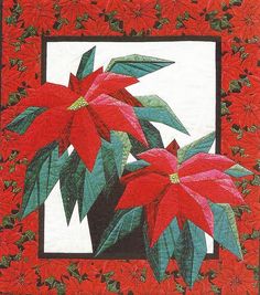 a red and green quilt with poinsettis on it