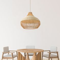 a wooden table with chairs and a light hanging from the ceiling in an empty room