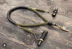 a pair of black and green lanyards sitting on top of a wooden table