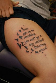 a woman with a tattoo on her thigh that says love is something you can't do without thinking about