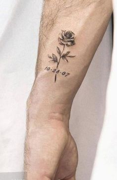 a person with a rose tattoo on their left wrist and the word love written in black ink