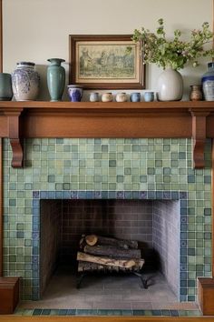 a fireplace with some vases on top of it and a fire place in the middle