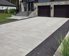 a large driveway with two garage doors on each side