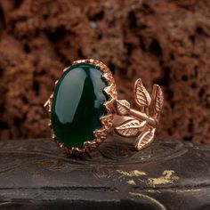 Green Aqeeq Flower Rose Gold Plated Silver Women Ring. Handmade in 925 gold color plating sterling silver with agate stone. On the ring Oval Green Aqeeq - Agate stone settled. At sides, flower figure settled with micro detailed ornament. Dimensions of stone is 20 mm x 15 mm. Average weight of Green Aqeeq Flower Rose Gold Plated Silver Women Ring is 9 gr. (depends on your ring size). Back side is open and stone touches your skin. Classic and exclusive style. Stone Type: Aqeeq - Agate Stone Color: Jade Jewelry With Polished Finish For Anniversary, Elegant Chalcedony Jewelry For Anniversary, Elegant Agate Jewelry For Anniversary, Anniversary Jewelry In Polished Jade, Anniversary Jade Jewelry With Polished Finish, Anniversary Jade Jewelry, Luxury Jade Ring Jewelry, Elegant Chalcedony Jewelry With Polished Finish, Nature-inspired Gold Jade Jewelry