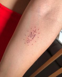 a woman's arm with a tattoo on it that says m is for mom