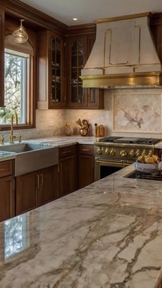 a kitchen with marble counter tops and wooden cabinets