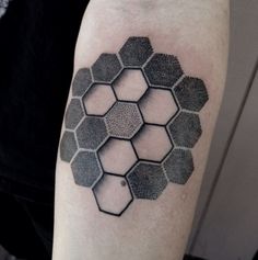 a man with a tattoo on his arm that has hexagons in it