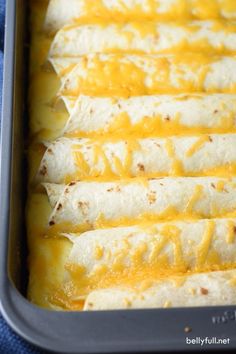 a pan filled with quesadillas covered in cheese