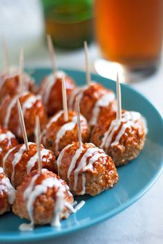 meatballs with white sauce and toothpicks on a blue plate