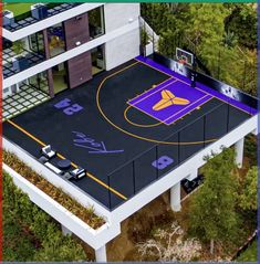 an aerial view of a basketball court in the middle of a building with cars parked on it