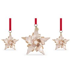 three ornament shaped like stars with red ribbon