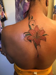 a woman with a flower tattoo on her back