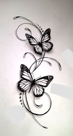 two butterflies with swirls and dots on white paper