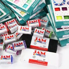 several boxes of jam paste sitting next to each other on top of a white table