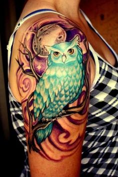 a woman with an owl tattoo on her arm