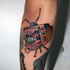 a man's arm with a cartoon tv on it and his mouth is open