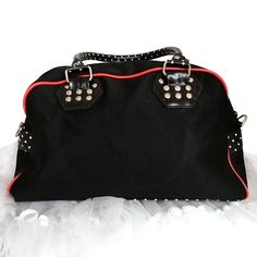 Cute looks and practicality--must be from Banned Apparel! The Cherry Skull Dots purse has bottom and sides in white dot print with a black front. Details include diagonal outside zipper with silver brads below, cherry skull applique, reinforced dotted handles finished with red bows, an adjustable and removable shoulder strap, top zip opening, and inside pockets and pen holders. Made from cotton; it has white dot lining. Measures 14" wide, 5" deep, 9" tall. It is 16"tall with handles. Skull Applique, Cute Looks, Strap Top, Red Bow, Cute Bags, Michael Kors Hamilton, Arm Candy, Dot Print, Pen Holders