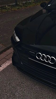 an audi car is parked on the side of the road