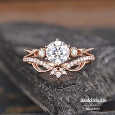 a close up of a diamond ring on a rock