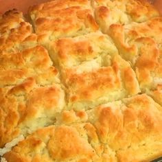 a casserole dish filled with cheese and biscuits