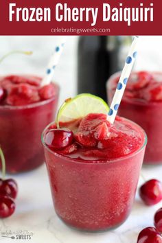 two glasses filled with red liquid and garnished with lime, cherries and lemon wedges