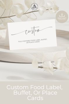 a place card with white flowers on it and the words custom food label, buffet or place cards