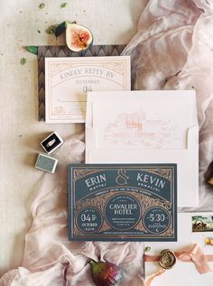 the wedding stationery is laid out neatly on top of the bed sheets and paper