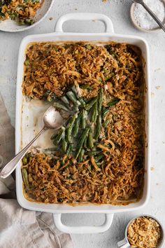 a casserole dish filled with green beans and shredded cheese