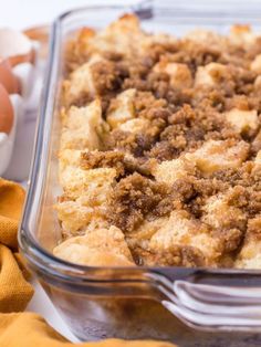 a casserole dish with bread crumbs and eggs in the back ground