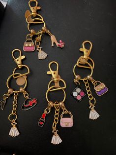 several different types of key chains on a black surface with other items attached to them